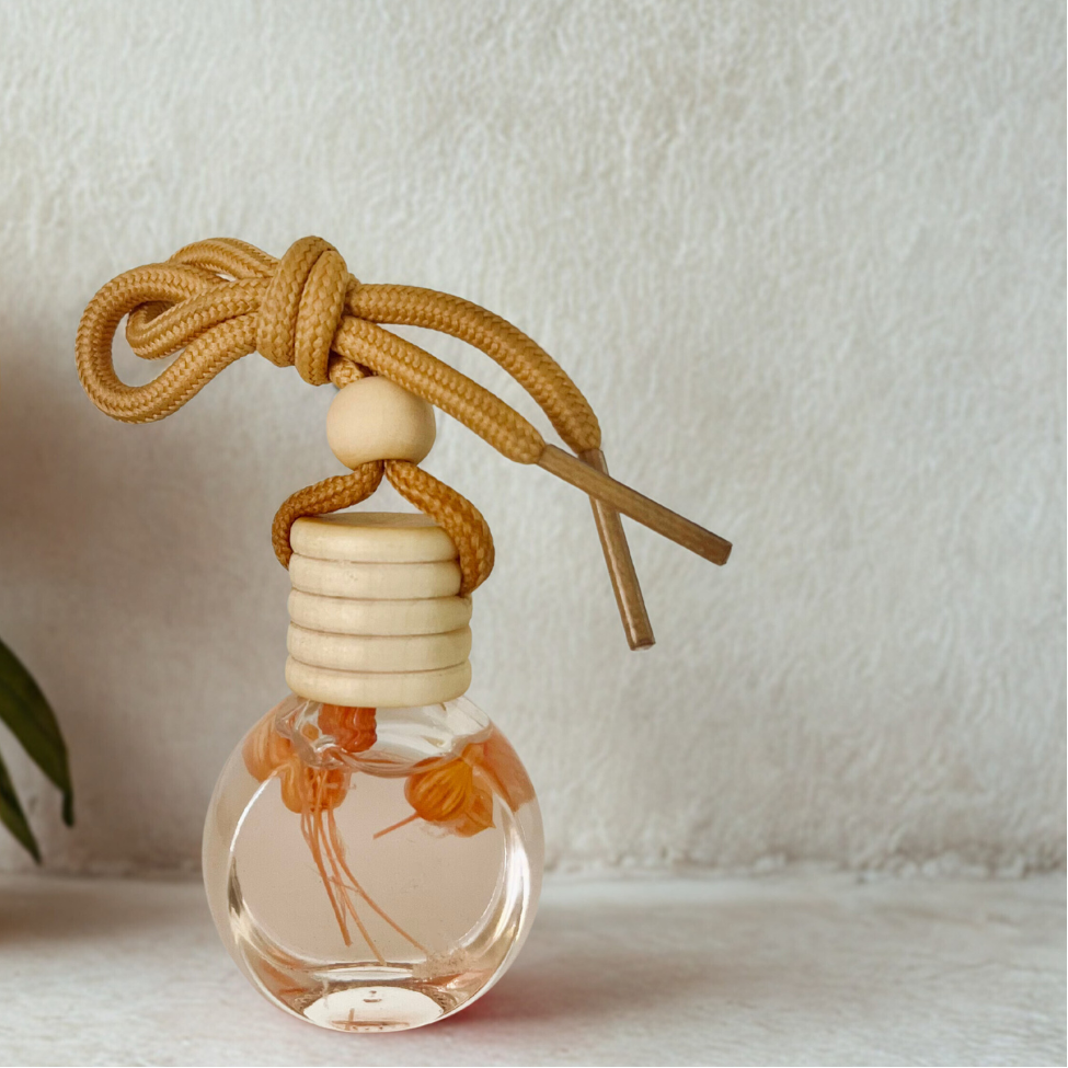 Car air freshener with flowers in it on a light background