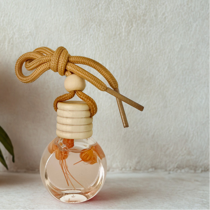 Car air freshener with flowers in it on a light background